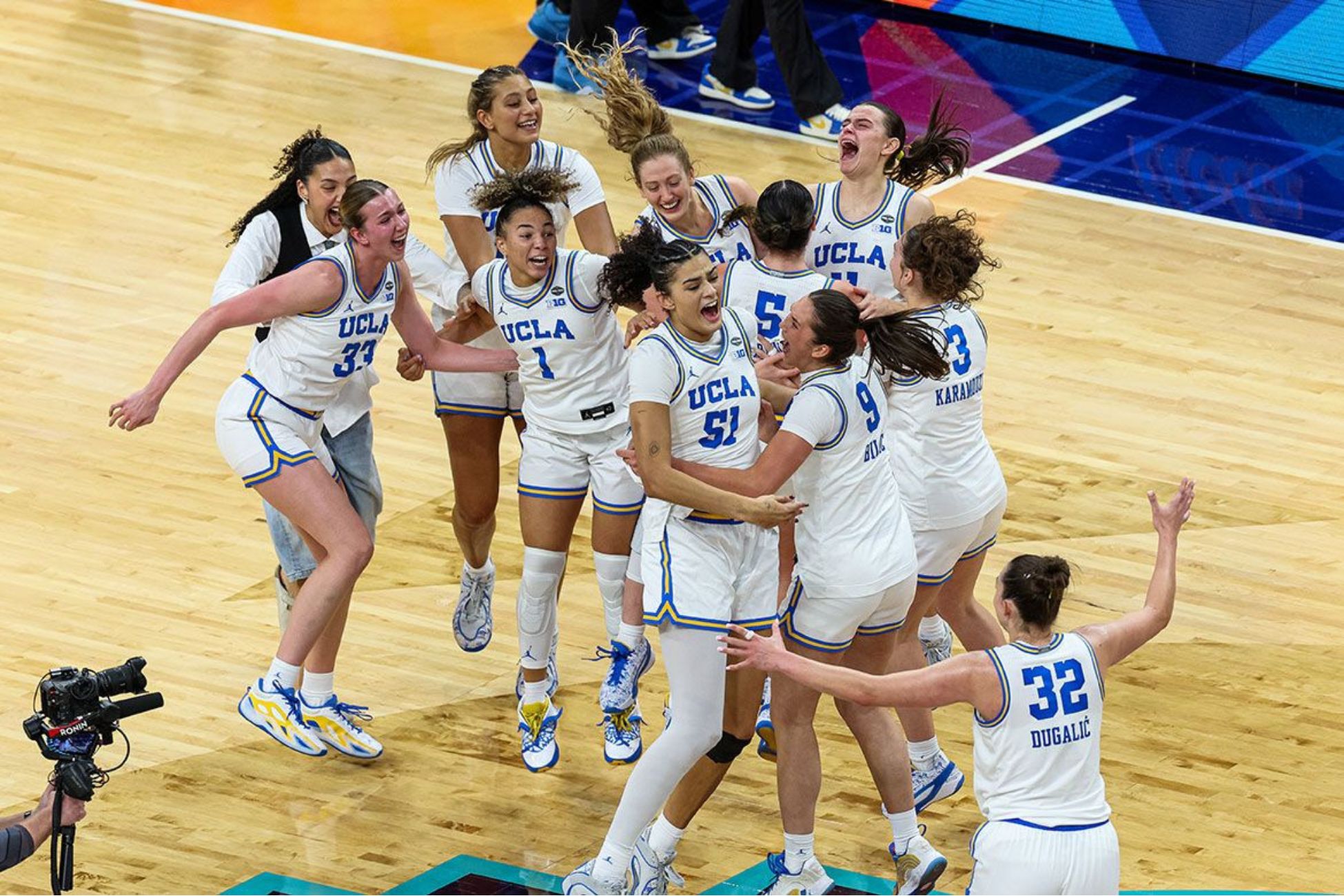 Group of young women cheering and jumping on basketball stadium