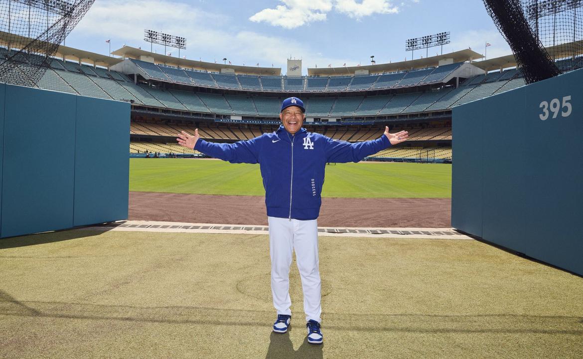 Dave Roberts stands in front of Dodger Stadium, making himself at home