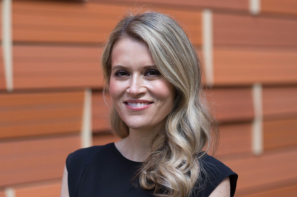 Headshot of researcher Naomi Eisenberger, with blond wavy hair and black top